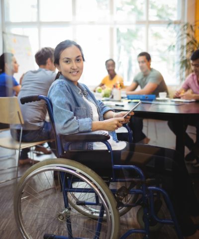handicapped-business-executive-using-digital-tablet handicapped-business-executive-using-digital-tablet